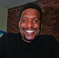 Headshot of Marc Thurman, a Black male with mustache and goatee